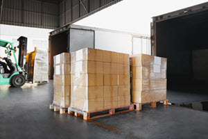 Pallets being loaded into shipping trucks