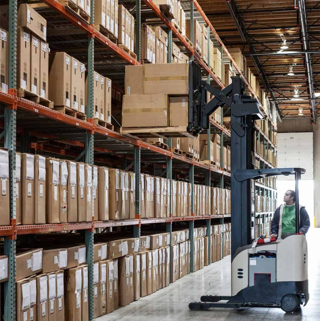 Logistics and Warehousing Trends: Challenges, AI, and the Road Ahead 3 an employee picking products off a rack
